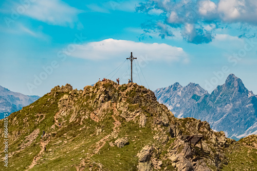 Alpine summer view with a summit cross at Mount Kreuzjoch, Schruns, Bludenz, Montafon, Vorarlberg, Austria photo