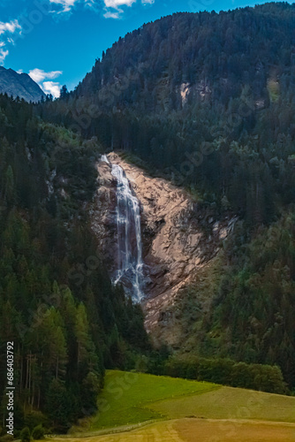 Alpine summer morning view with a waterfall near Mutterbergalm, Stubaital valley, Innsbruck, Austria