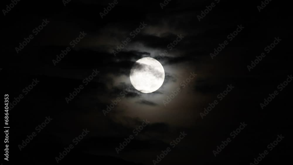 clouds moving in front of full moon at night clouds moving in front of full moon at night