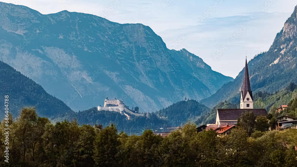 Alpine summer view with a church, Fortress Hohenwerfen and the Tennengebirge mountains near Pfarrwerfen, St. Johann im Pongau, Salzburg, Austria