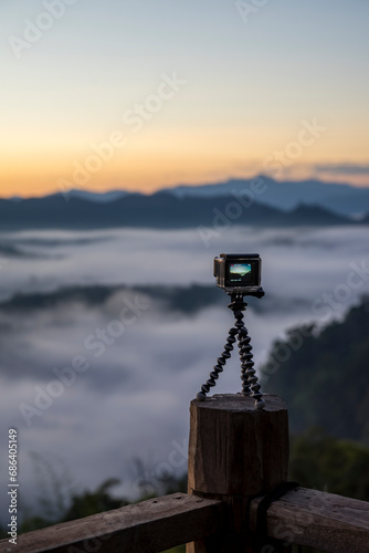 Closeup of GoPro Hero 4 camera on  tripod , The video was filmed in the morning fog.