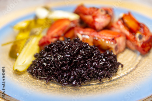 Traditional rustic Brazilian food, black rice, smoked pork ribs and pickles © Adilson