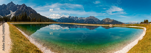 High resolution stitched alpine summer panorama with reflections in a lake at Serles cable car station  Mieders  Stubaital valley  Innsbruck  Austria