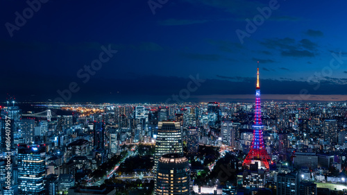 Panoramic view of Tokyo tower with Diamond Veil light up and Tokyo cityscape at magic hour. photo