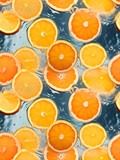 Seamless Pattern with orange and lemon slices in transparent water. Aerial view photo of oranges cut in half. Juicy oranges in top view. Close up orange slices. Refreshing Orange taste advertisement