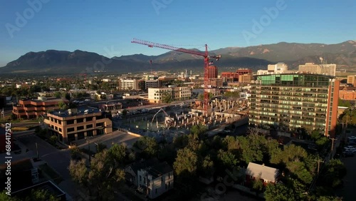 Aerial view of a tower crane at a construction site near the mountains