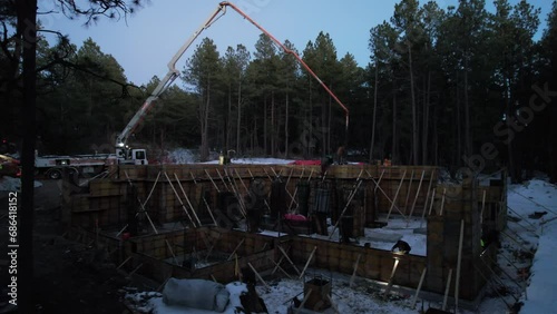 Aerial view of construction workers building a house