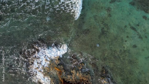 Aerial view of stingrays swimming under waves in Mexico