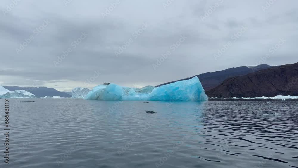 Static shot of a particularly blue iceberg. Rødefjord, Scoresbysund, Greenland. Static shot of a particularly blue iceberg. Rødefjord, Scoresbysund, Greenland.