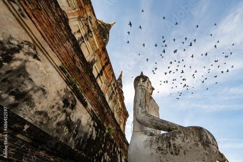 Buddha head and pagoda in Wat Yai Chai Mongkhon in sunrise with birds photo