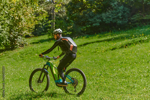  In the radiant glow of a sunny day, a fitness enthusiast, donned in professional gear, pedals through the park on his bicycle, embodying strength and vitality in a dynamic outdoor workout