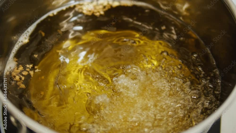 Boilng water, oil on metalic pot close-up macro. Professional kitchen on modern restaurant cafe Boilng water, oil on metalic pot close-up macro. Professional kitchen on modern restaurant cafe