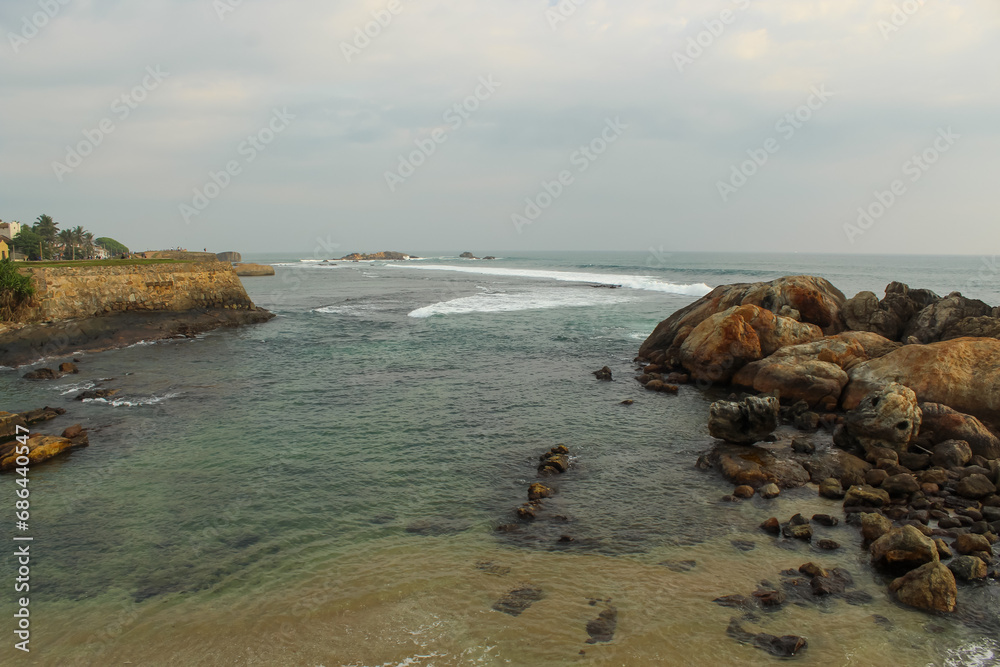 The aerial view of the waves crashing into the rocky shore of Sri Lanka The aerial view of the waves crashing into the rocky shore of Sri Lanka