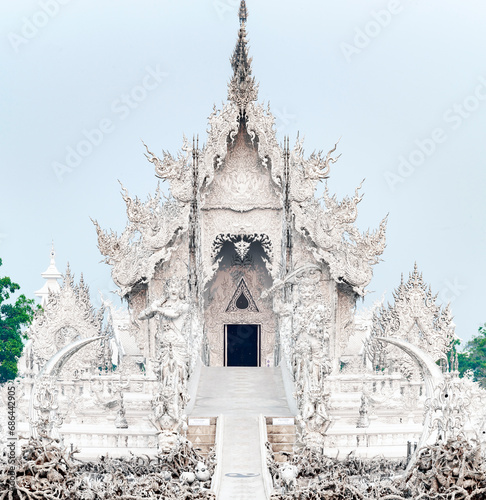 Wat Rong Khun,the White Temple,and bridge over Hell,at dawn,outskirts of Chiang Rai city,Northern Thailand.