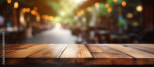 Brown wooden table and blurred background with bokeh image for your photomontage or product display
