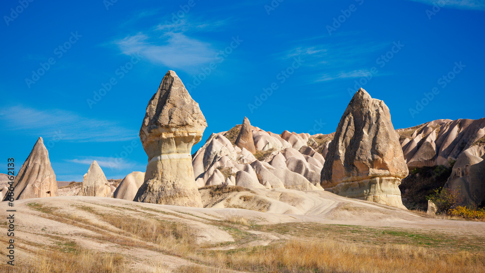 Fairy chimneys on blue sky- Famous rock formations in Cappadocia, Turkey