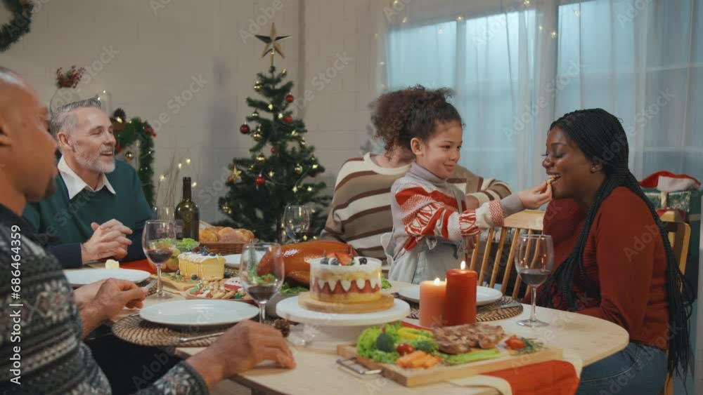 Multi-ethnic big family celebrating Christmas party together in house. Multi-ethnic big family celebrating Christmas party together in house.
