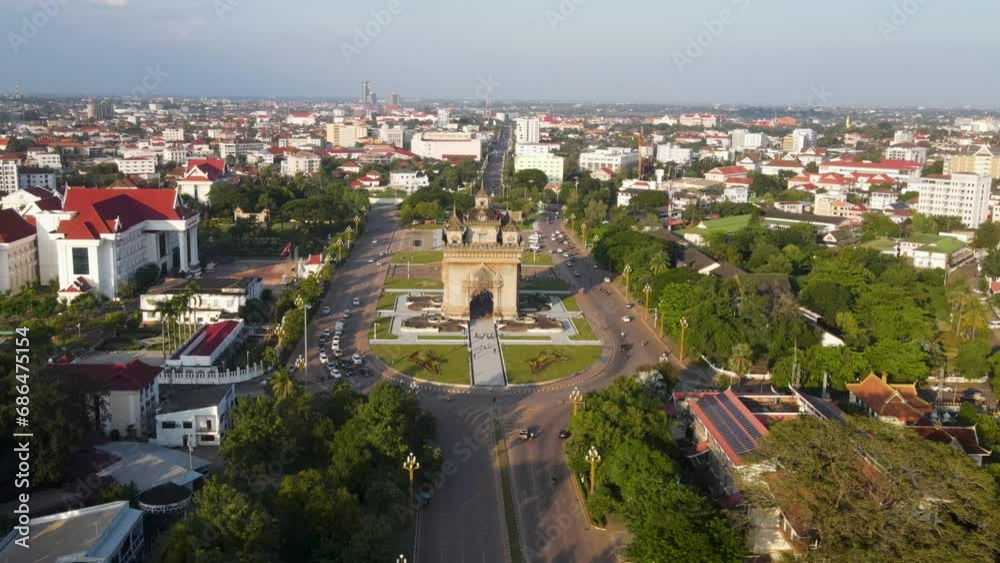 Aerial Flying Towards Patuxai monument In Vientiane With Light Traffic Going Around It. Push Forward, Establishing Shot Aerial Flying Towards Patuxai monument In Vientiane With Light Traffic Going Around It. Push Forward, Establishing Shot