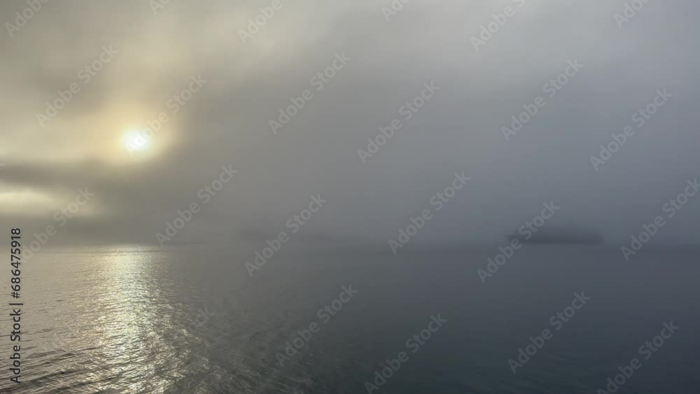 A cruise ship that looks like a ghost ship near Ittoqqortoormiit in a very foggy morning. Scoresbysund, Greenland. A cruise ship that looks like a ghost ship near Ittoqqortoormiit in a very foggy morning. Scoresbysund, Greenland.