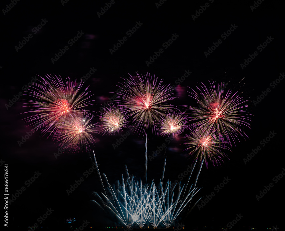 Fototapeta premium Fireworks show under defocus or blur concepts with isolated black background at night, this celebration is for the International Fireworks Festival in Pattaya on Nov 24-25 in Thailand