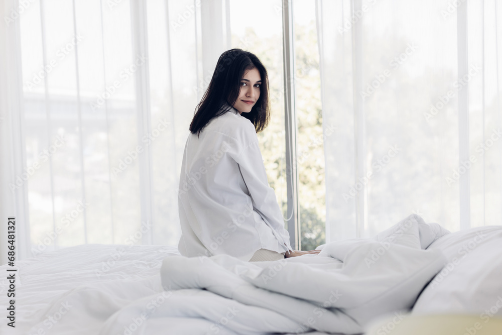 Woman stretching in bed after wake up. stretching and happy woman waking up in the morning after sleep, rest and relax at home. Woman stretching in bed after wake up. stretching and happy woman waking up in the morning after sleep, rest and relax at home.