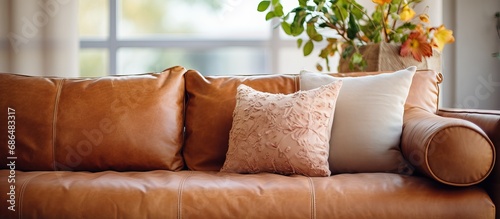 A close up of a living room s beige leather couch photo