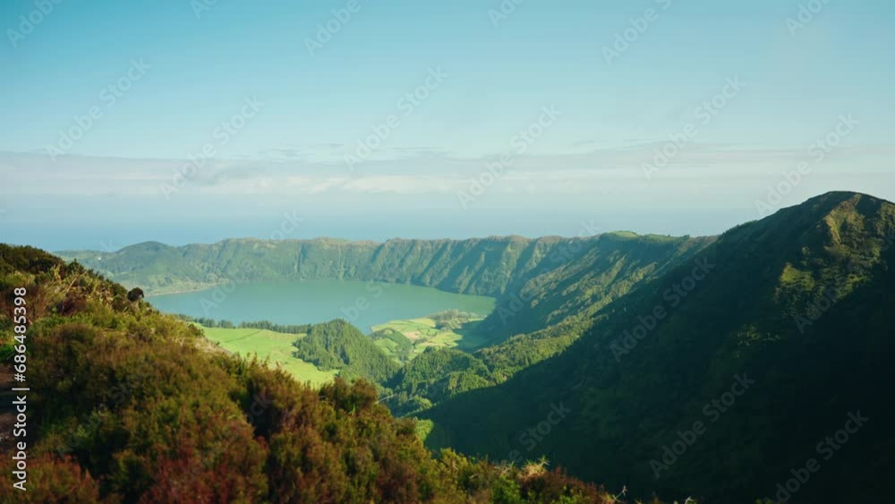 Picturesque view from miradouro viewpoint overlooking the boca do inferno volcanic lake landscape on Sao Miguel island in the Azores. Beautiful green landscape, sunny day, clear blue sky. Picturesque view from miradouro viewpoint overlooking the boca do inferno volcanic lake landscape on Sao Miguel island in the Azores. Beautiful green landscape, sunny day, clear blue sky.