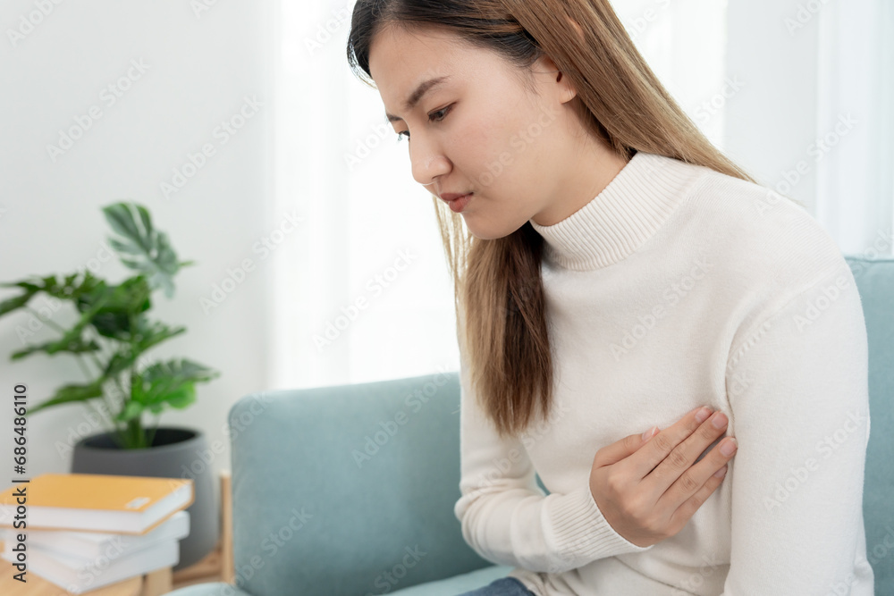 hand hold chest with heart attack symptoms, asian woman have chest pain caused by heart disease, leak, dilatation, enlarged coronary heart, press on the chest with a painful expression hand hold chest with heart attack symptoms, asian woman have chest pain caused by heart disease, leak, dilatation, enlarged coronary heart, press on the chest with a painful expression