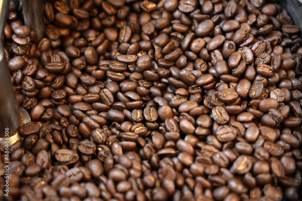 Fototapeta premium Coffee beans in a coffee grinder. Coffee beans background