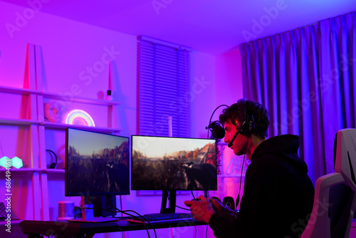 Cuadro en lienzo Caucasian gamer boy focus on playing fps shooting game as a sniper with his team