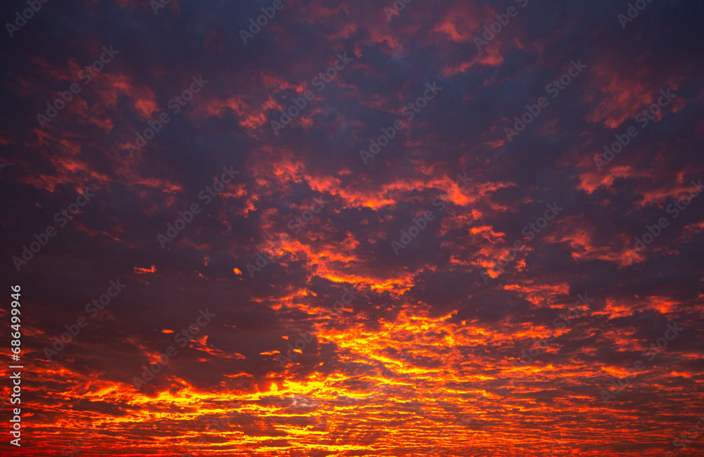Beautiful sunrise in the sky with clouds. Sky background. Nature.