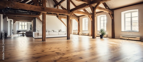Spacious loft with wooden floor and beams © Vusal