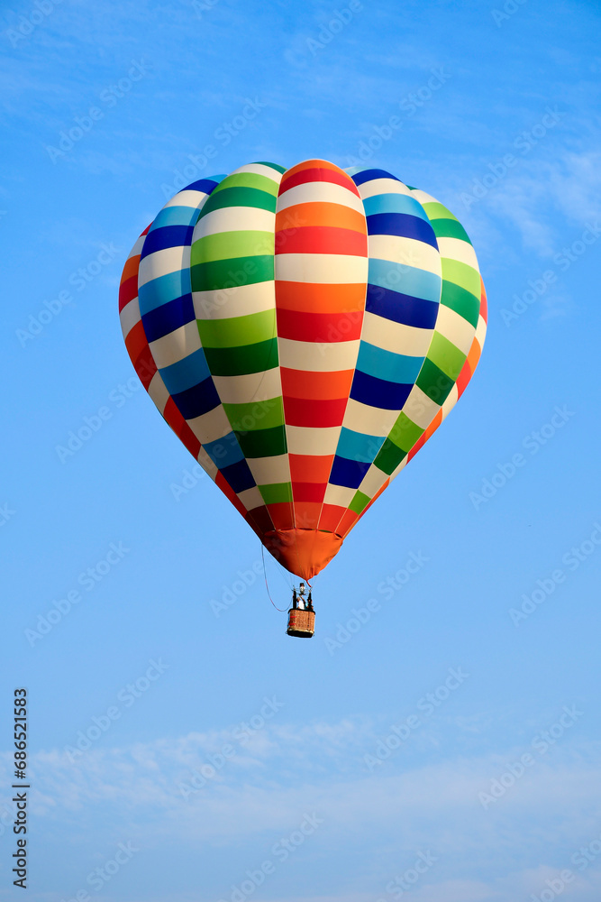 Fototapeta premium Colorful balloon over blue sky in the bright sun light.