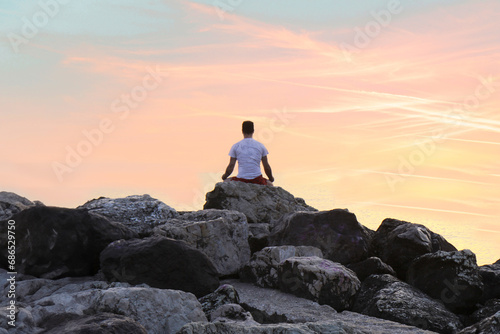 meditation on the rocks, silhouette of a person at sunset