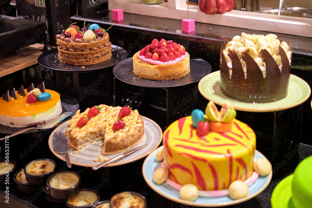 Vibrant cakes on display, bursting with color and sweetness. Such indulgence contrasts with the rising health-conscious trends.