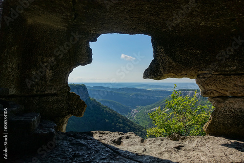 Mangup-Kale cave city, sunny day. Mountain view from the ancient cave town of Mangup-Kale in the Republic of Crimea, Russia. Bakhchisarai. View from inside the cave at sunset