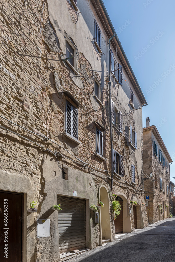 old houses in narrow street, Volterra, Italy