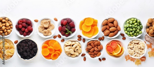 Assorted healthy snacks on white table, top-down view, close-up.