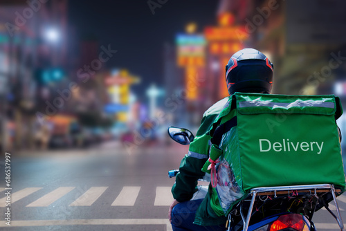 At Street Food in night city, Thailand, delivery drivers are making deliveries to consumers who have placed online orders photo