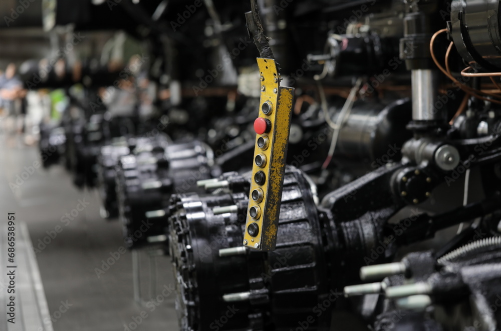 Fototapeta premium Control panel with buttons in production of car parts and engines. Concept of car repair workshop and industrial production of engines and spare parts