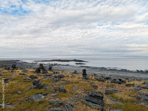 The rocky coast of the Barents Sea. Beautiful view of the rocks and the coast of the Rybachy and Sredny peninsulas, Murmansk region, Russia. The landscape is the harsh beauty of the north.