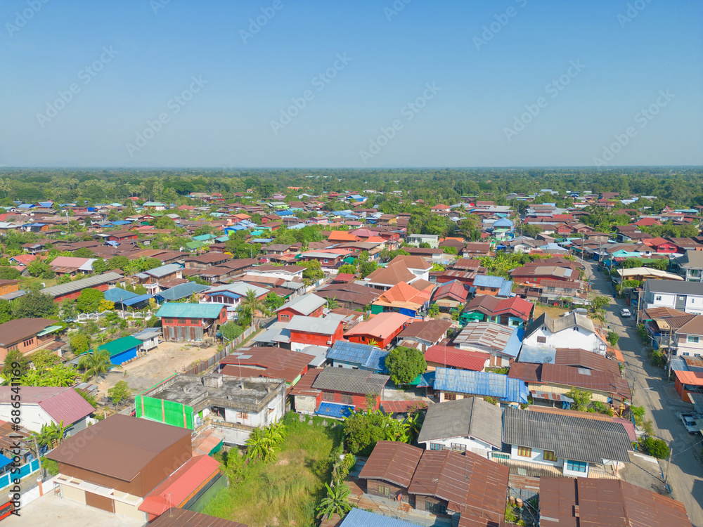 Aerial view of local residential neighborhood roofs. Urban housing development from above. Top view. Real estate in Sukhothai urban city town, Thailand. Property real estate.