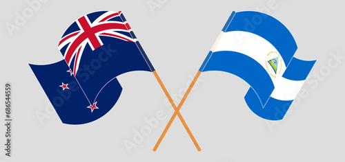 Crossed and waving flags of New Zealand and Nicaragua