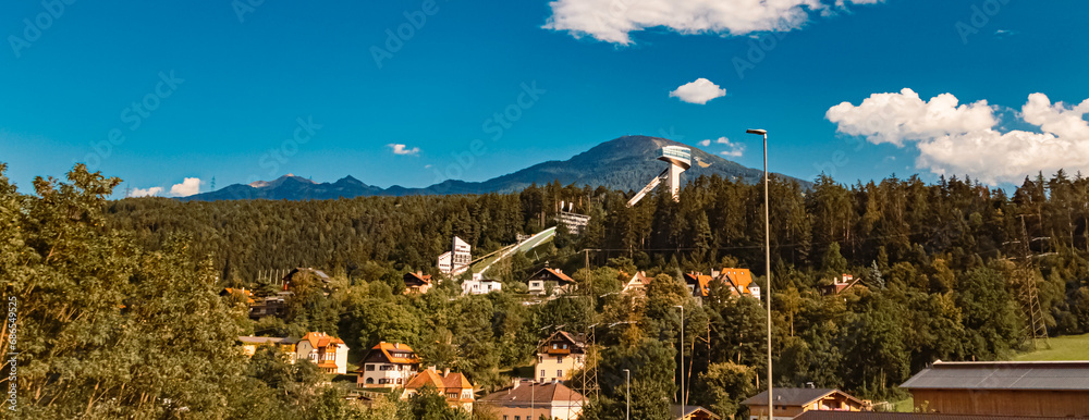 Alpine summer view with the famous Berg Isel Ski Jump Tower and Mount Patscherkofel near Innsbruck, Austria
