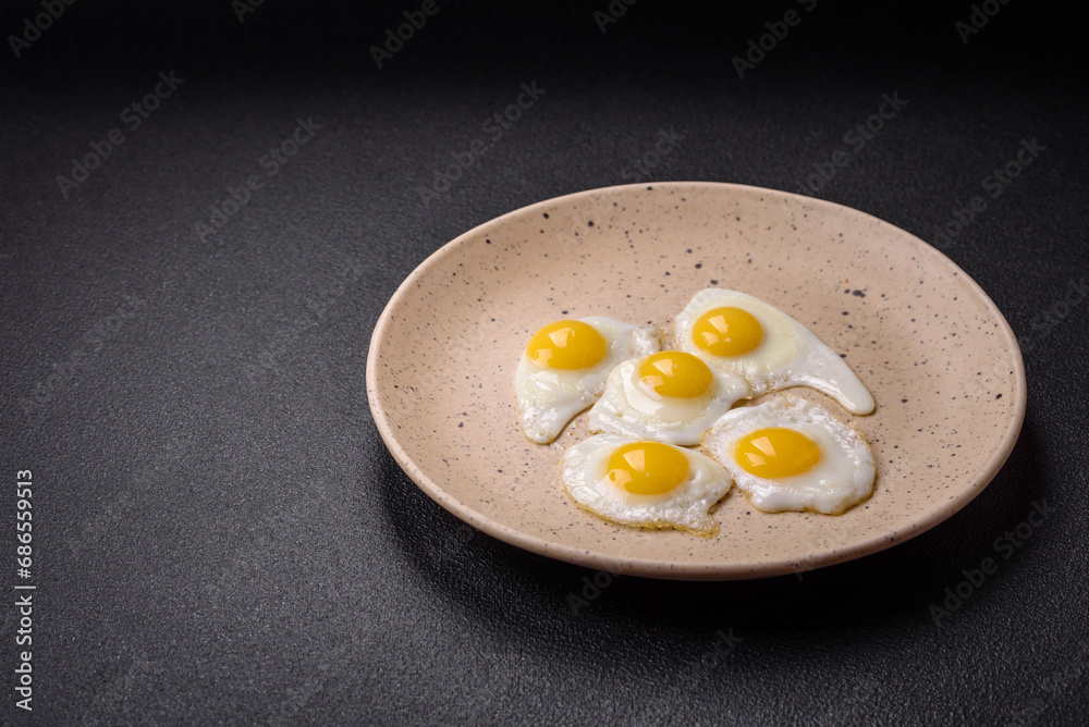 Delicious nutritious breakfast of fried quail eggs, bacon, legumes and cherry tomatoes Delicious nutritious breakfast of fried quail eggs, bacon, legumes and cherry tomatoes