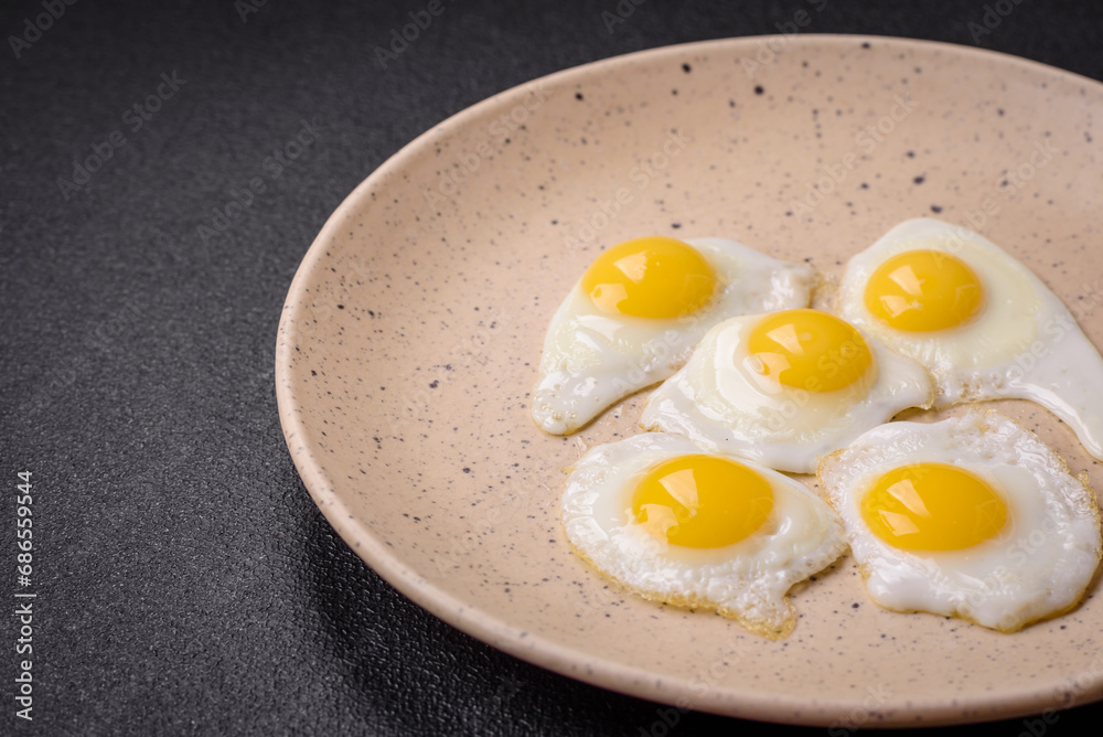 Delicious nutritious breakfast of fried quail eggs, bacon, legumes and cherry tomatoes Delicious nutritious breakfast of fried quail eggs, bacon, legumes and cherry tomatoes