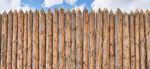 Palisade and a little of cloudy sky as abstract rustic or historical background.