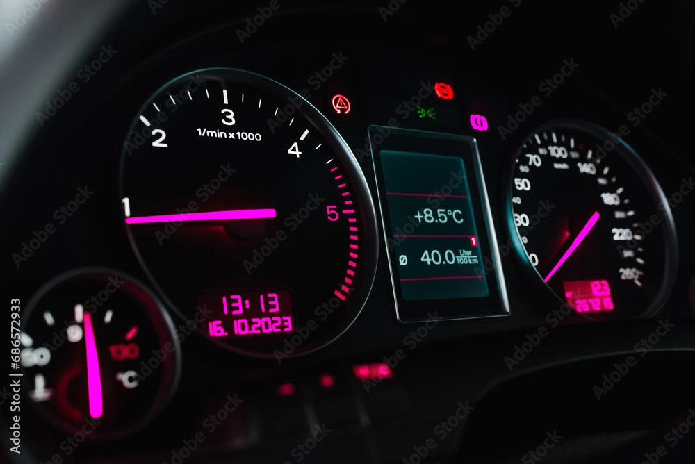 Fototapeta premium Car's dashboard.Modern car dashboard panel at night time.Closeup,selective focus.Toned.