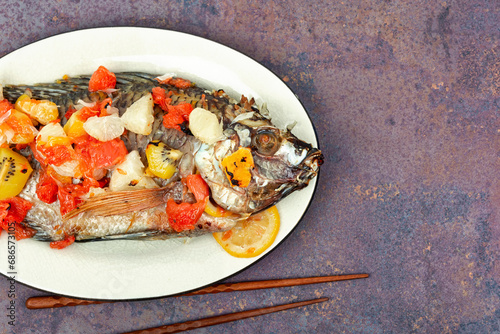 Roasted whole tilapia with citrus sauce. photo