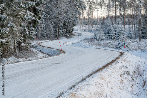 Rural winter road with lots of curves in forest